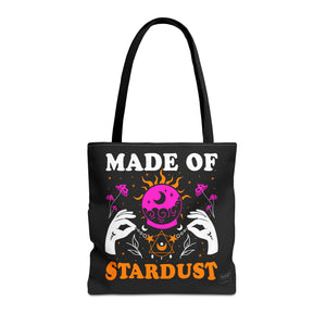 Front view of Made of Stardust tote bag with black handles and cosmic text