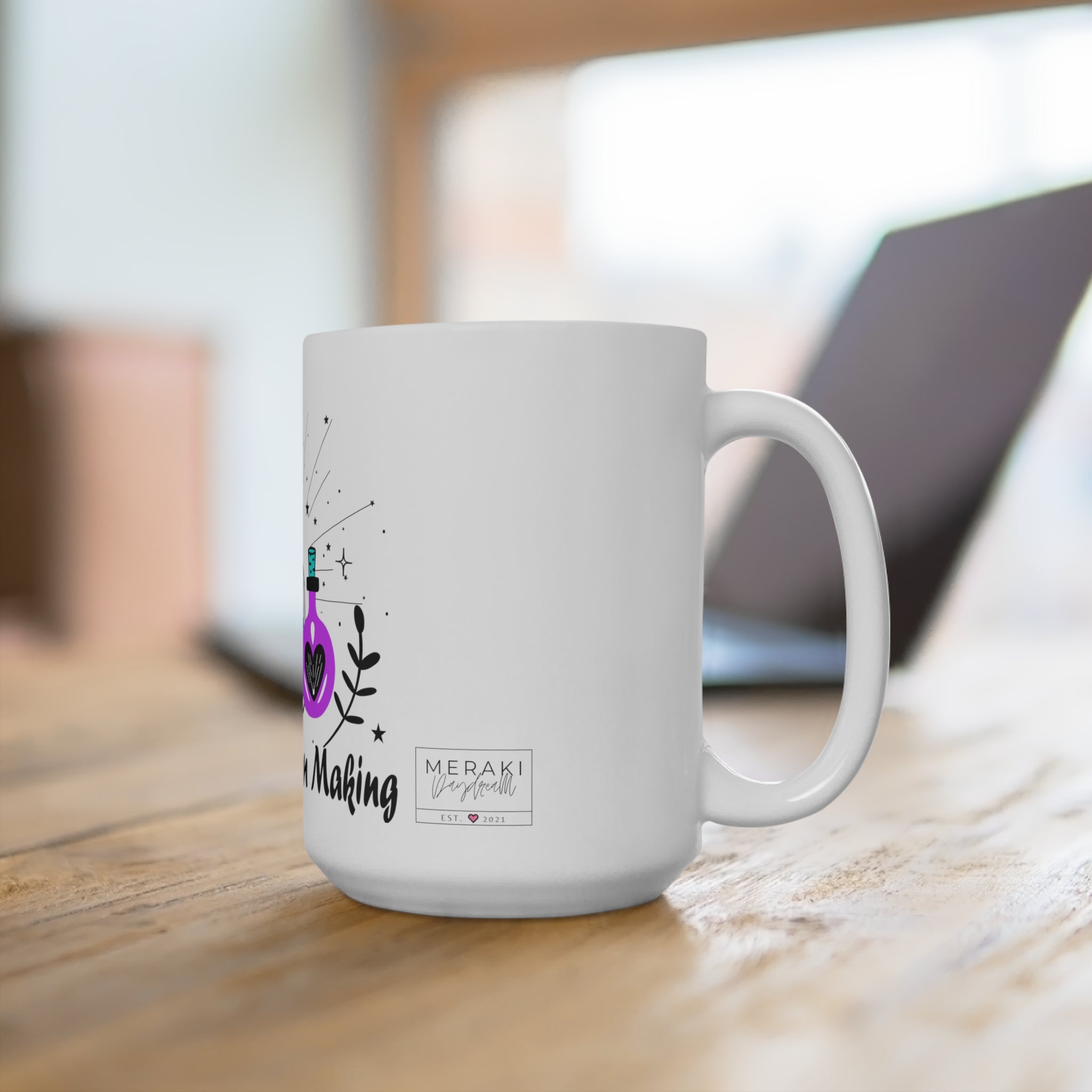 Printed mug in kitchen beside cauldron-style teapot