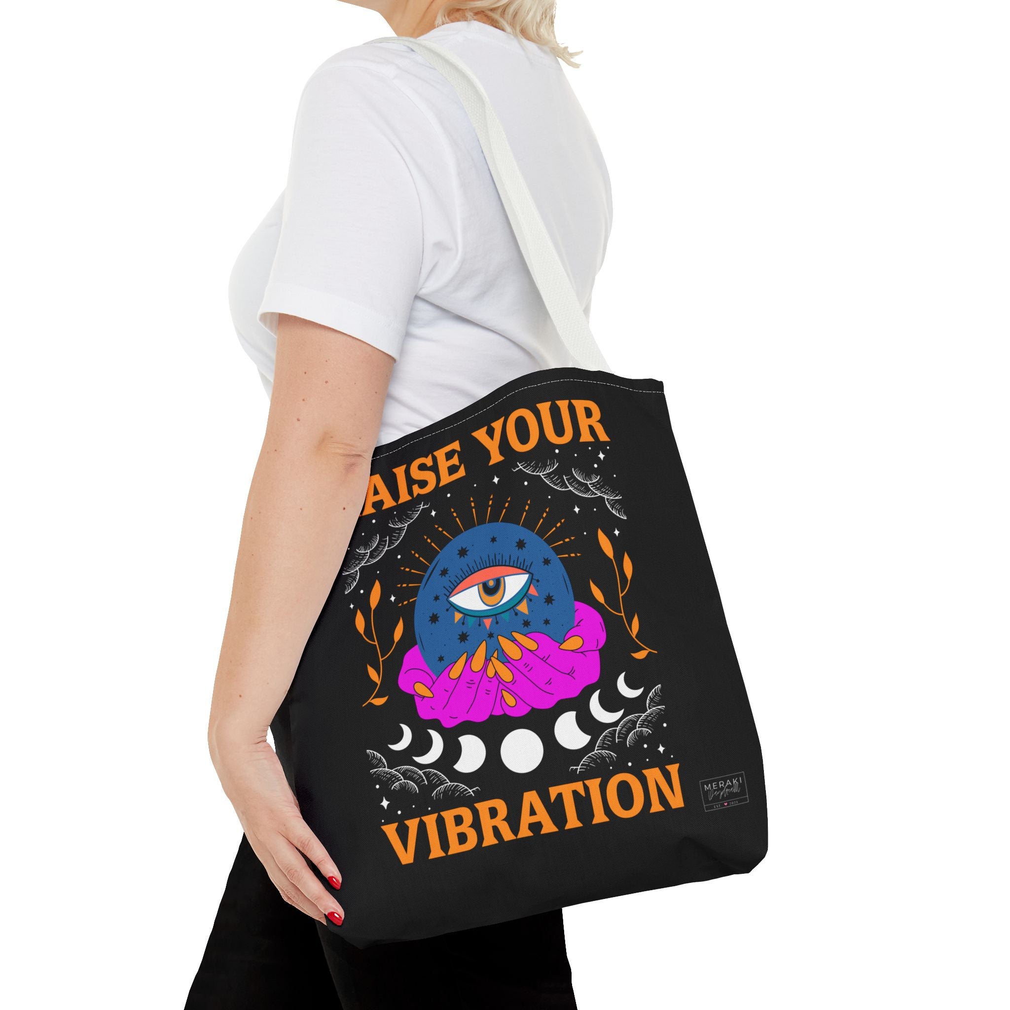 Woman using tote bag styled with casual outfit and crystals inside