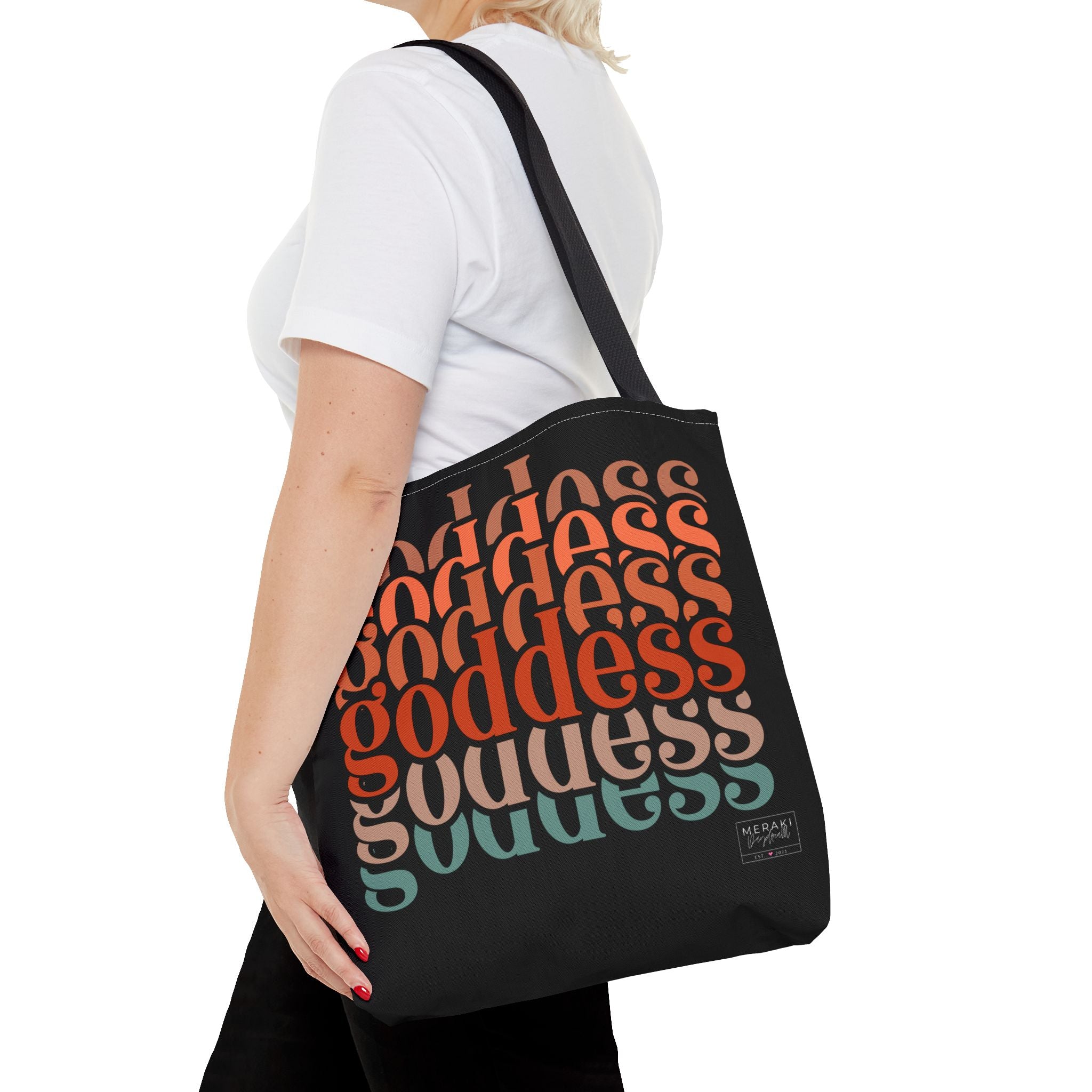 "Woman walking with black handle Goddess tote and journal in hand"