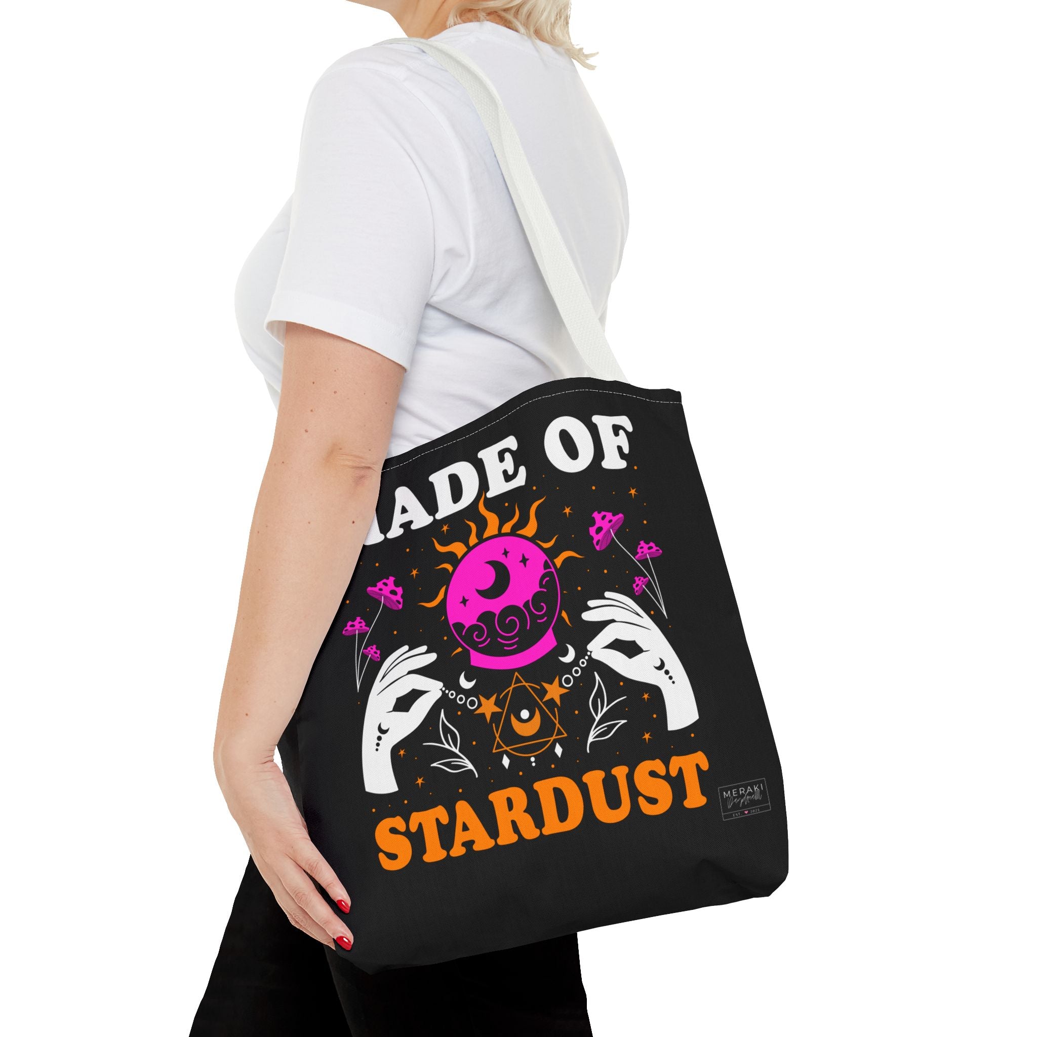 Woman walking with white handle cosmic tote and soft outfit