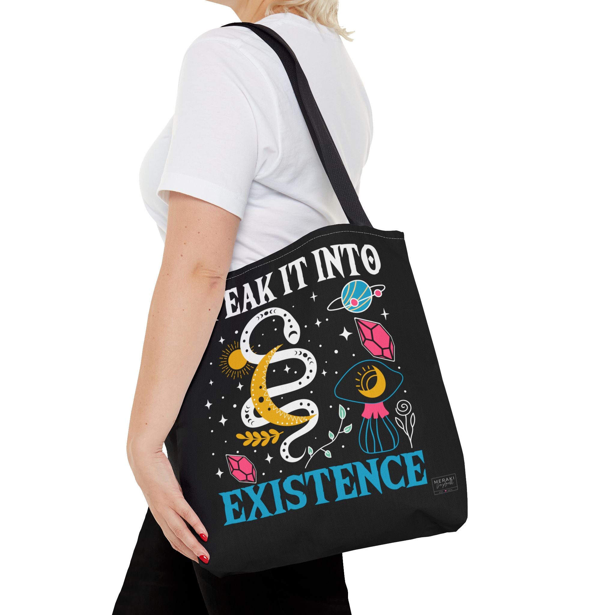 Woman wearing black handle Speak It Into Existence tote bag on shoulder