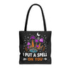 Front view of I Put A Spell On You tote bag with black handles and bold text design