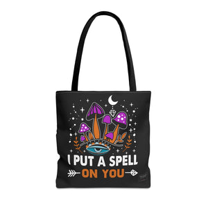 Front view of I Put A Spell On You tote bag with black handles and bold text design