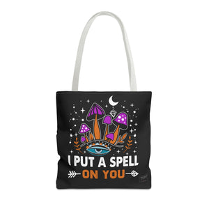 Front view of white handle spell tote bag with spiritual print and clean lines