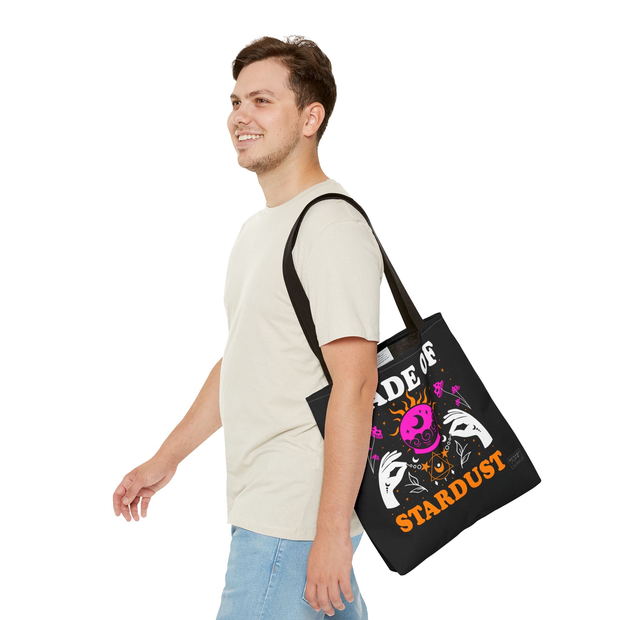 Man carrying black handle cosmic tote with journal and sage inside
