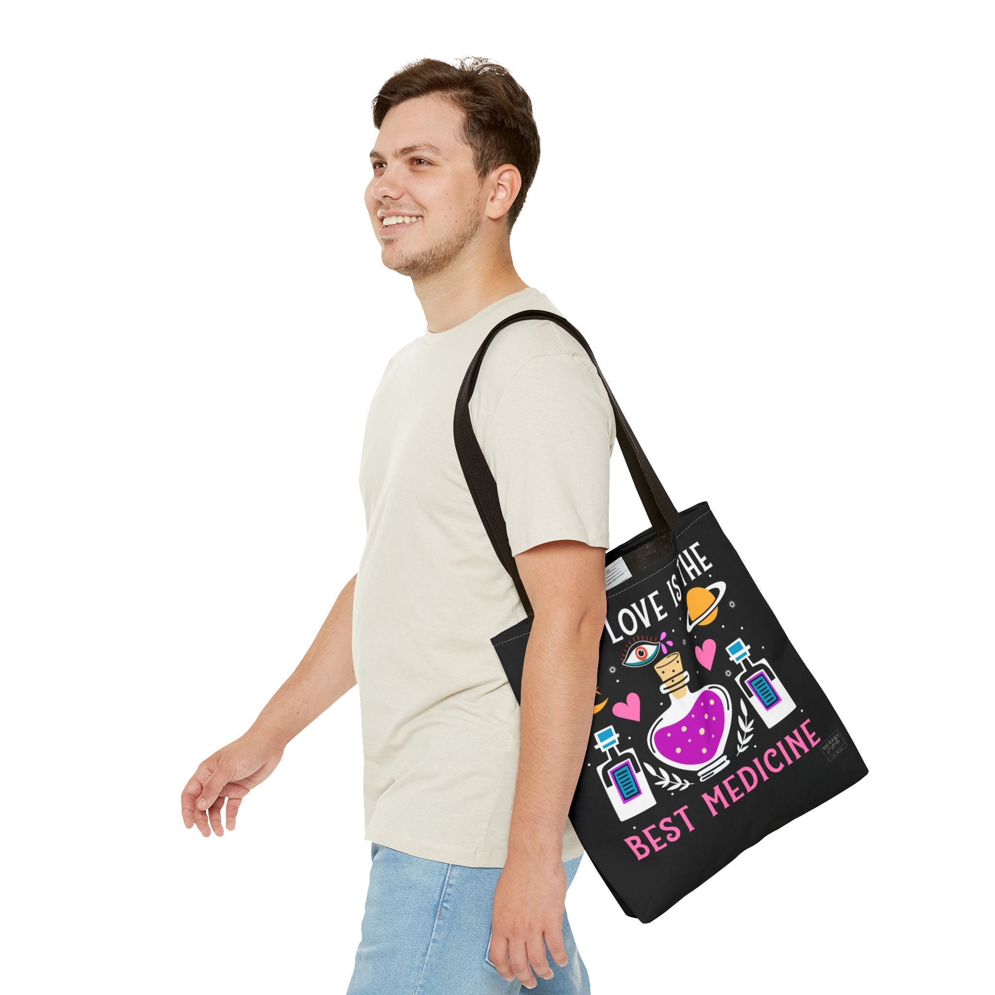 Man carrying black handle spiritual tote bag with journal and headphones inside