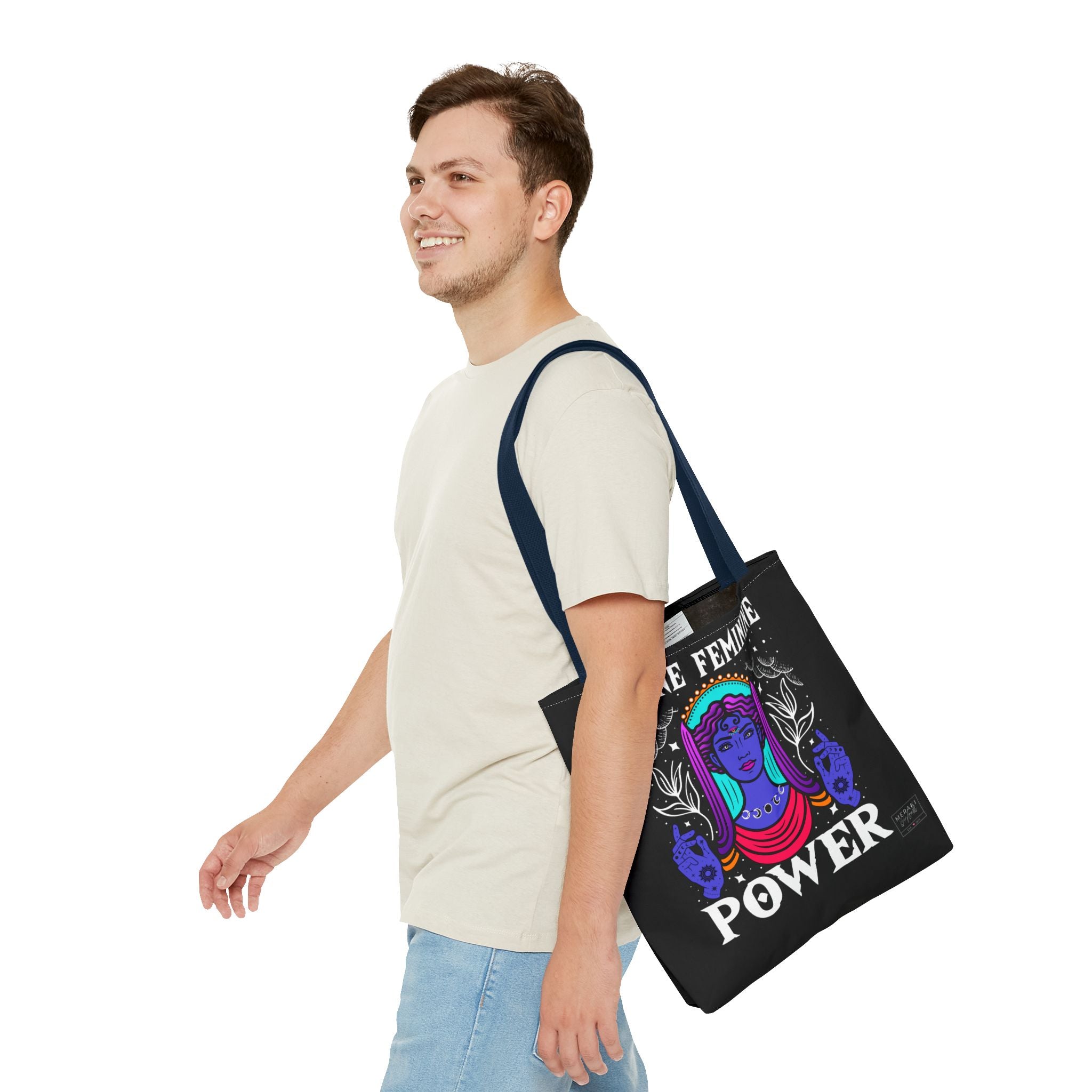 Man carrying navy handle Divine Feminine tote bag with grounded expression