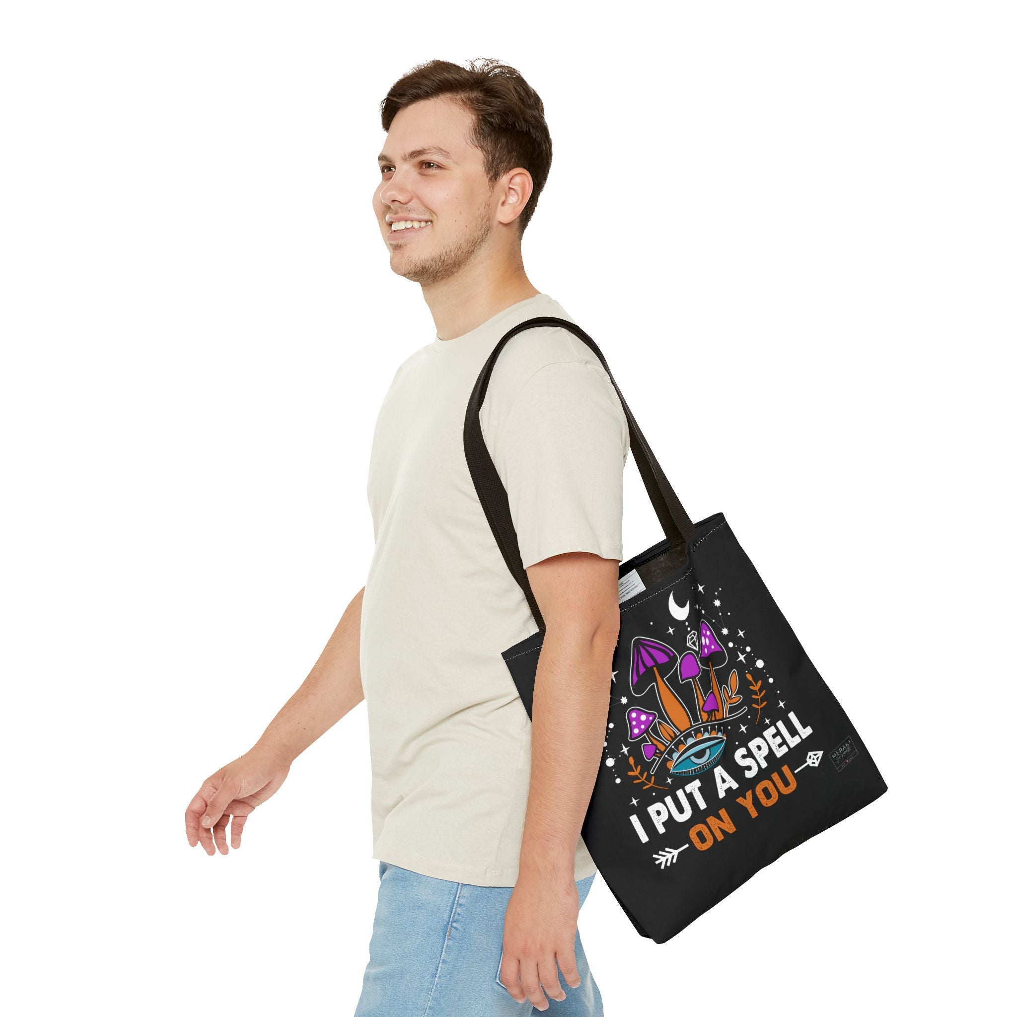 Man wearing black handle tote bag with spellwork journal inside
