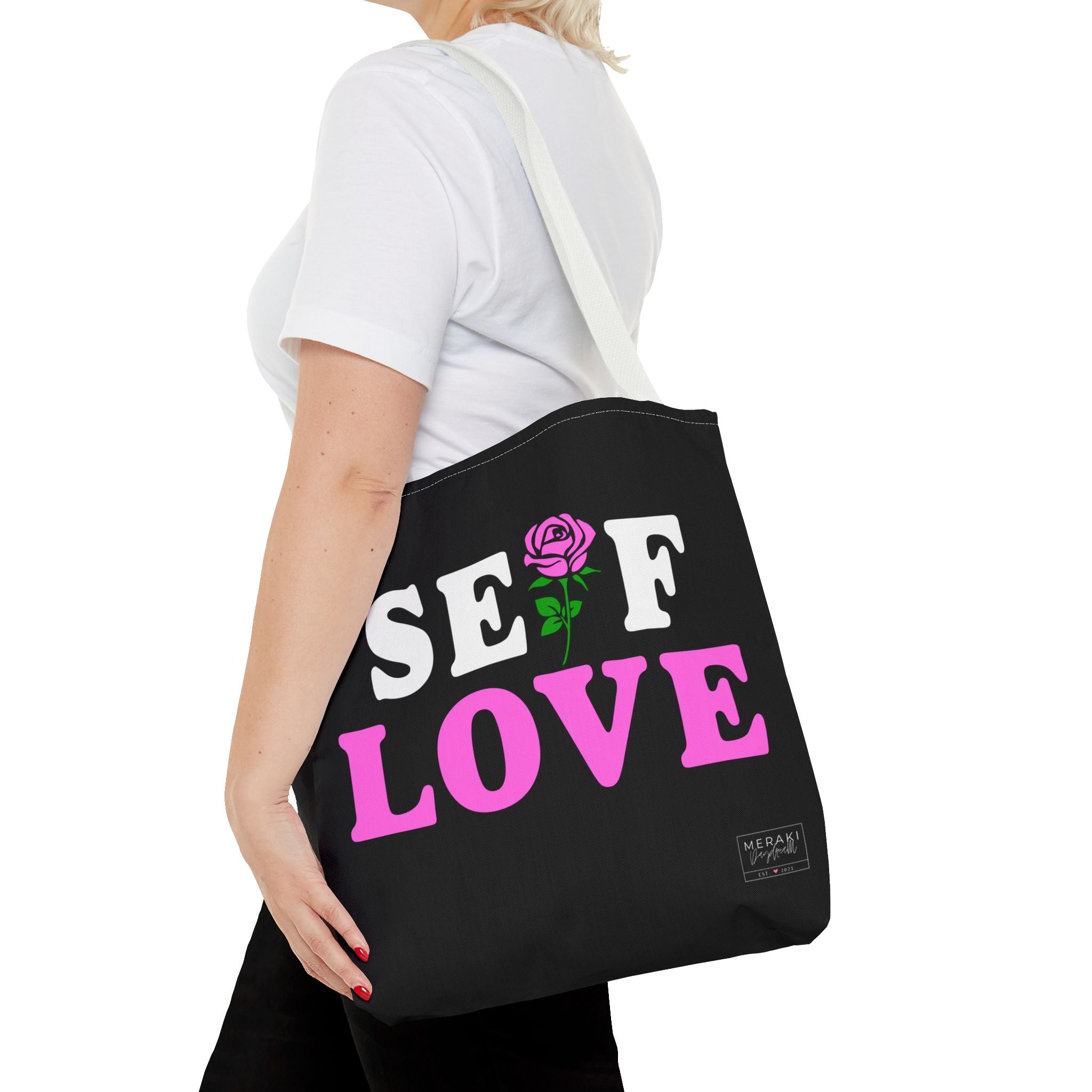 White handle Self Love tote carried by woman outdoors