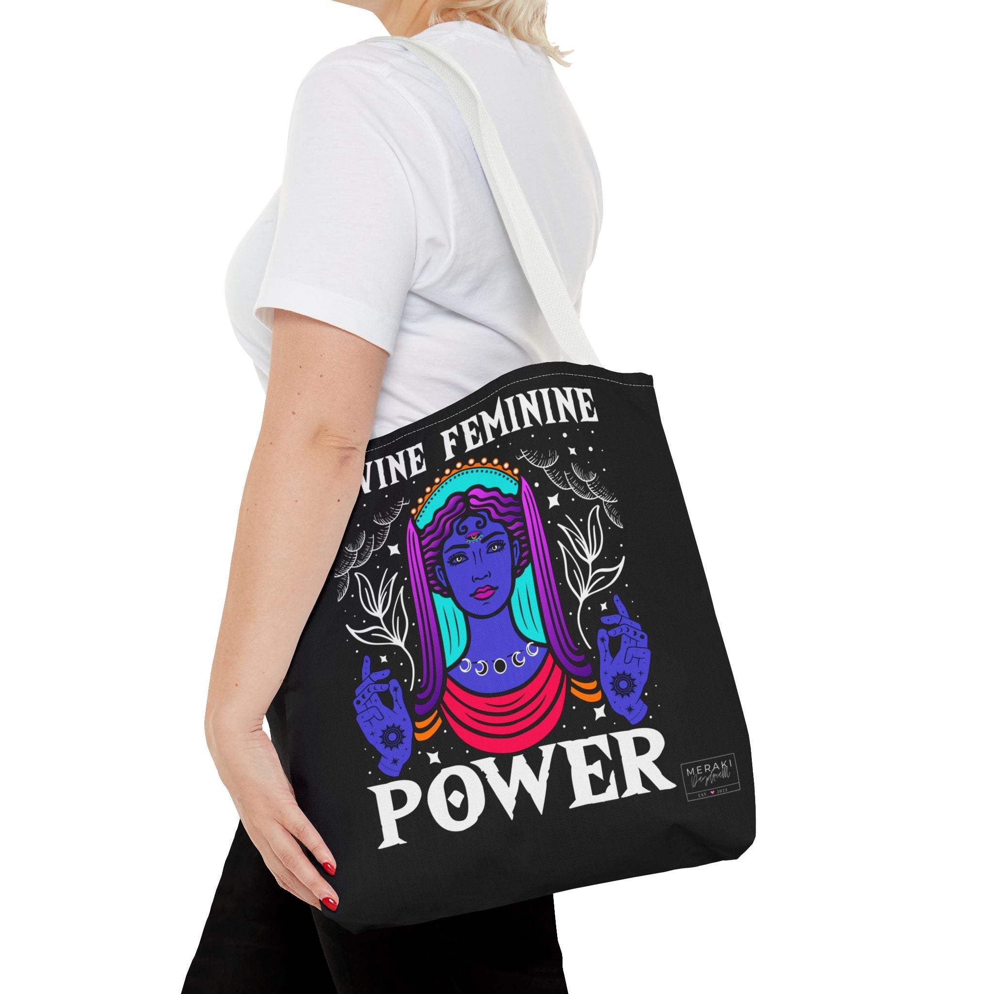 Woman carrying white handle Divine Feminine Power tote with cozy neutral outfit