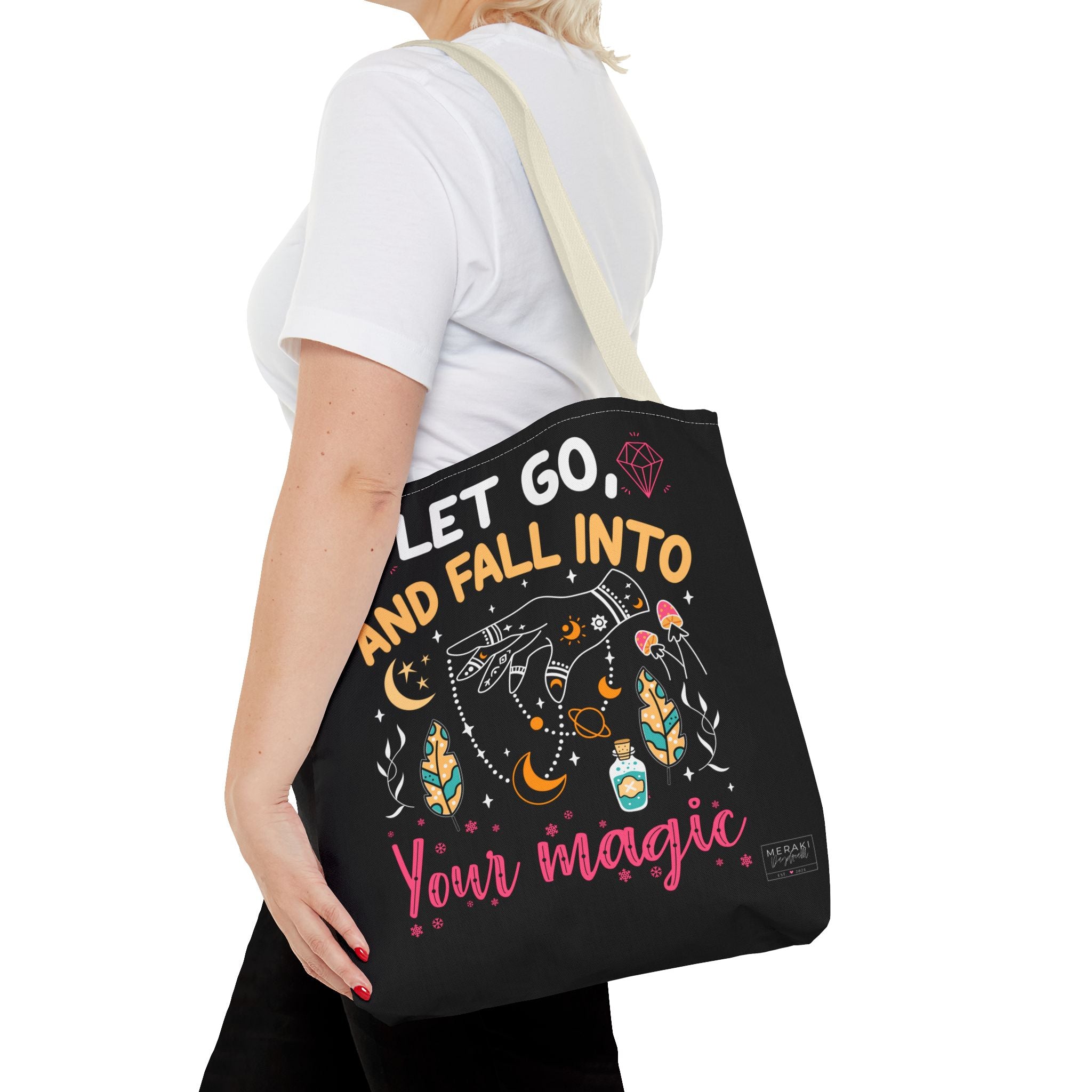 Woman holding Fall Into Your Magic tote bag beige