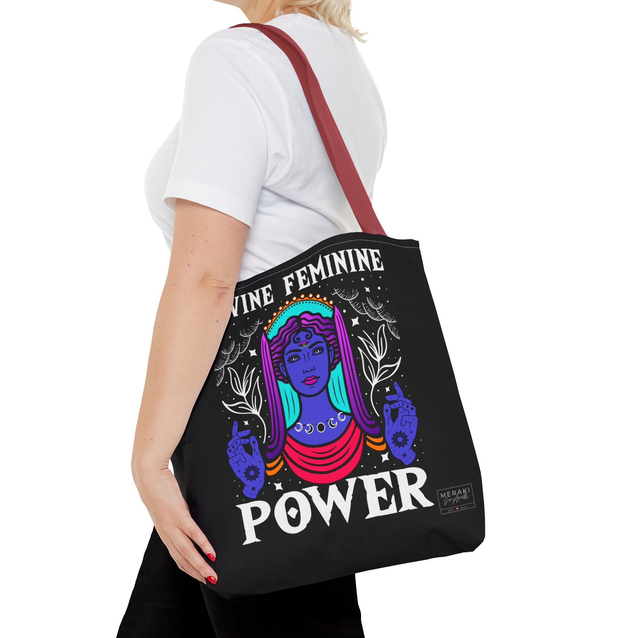 Woman holding red handle Divine Feminine tote while walking