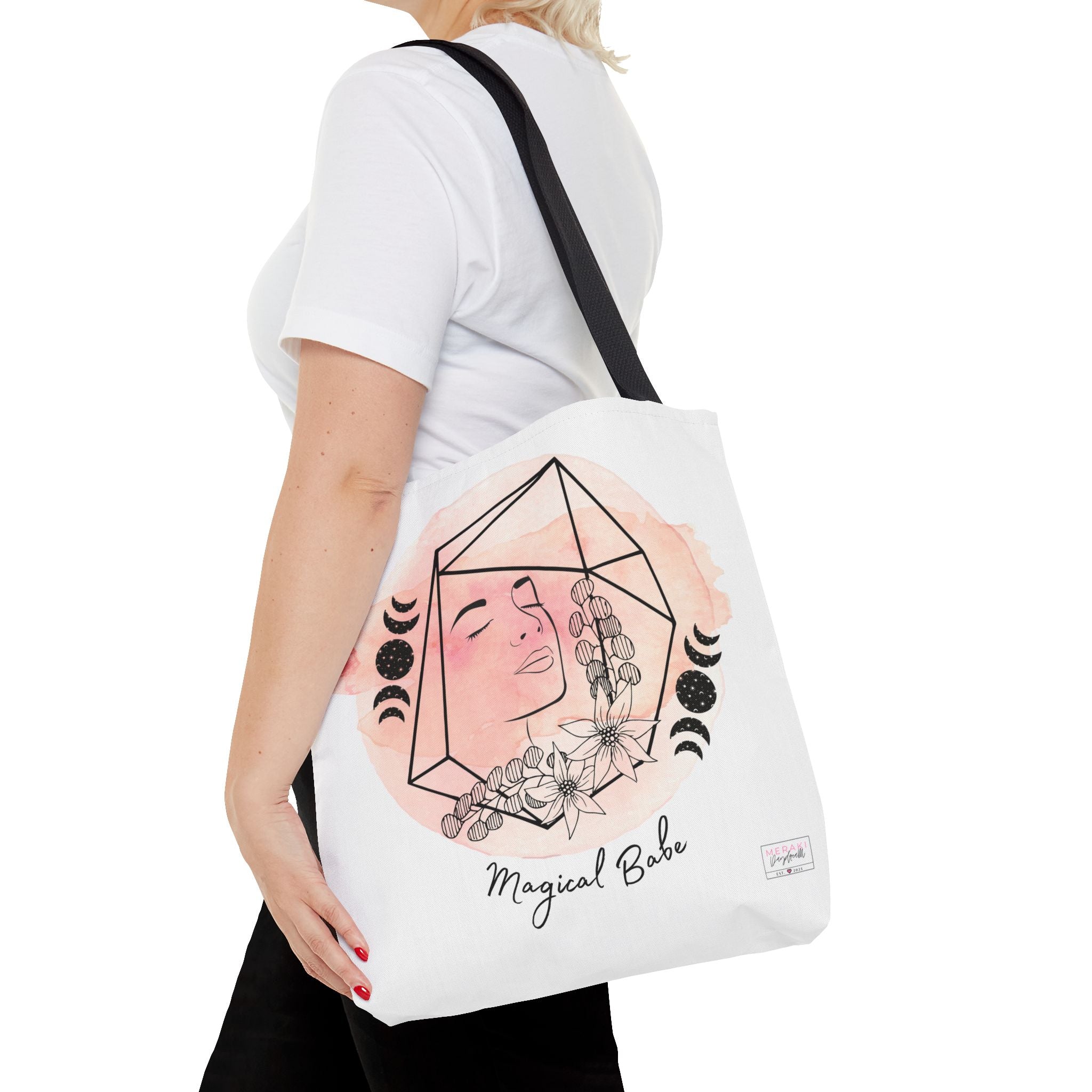 "Woman wearing black handle Magical Babe tote while journaling outdoors"

